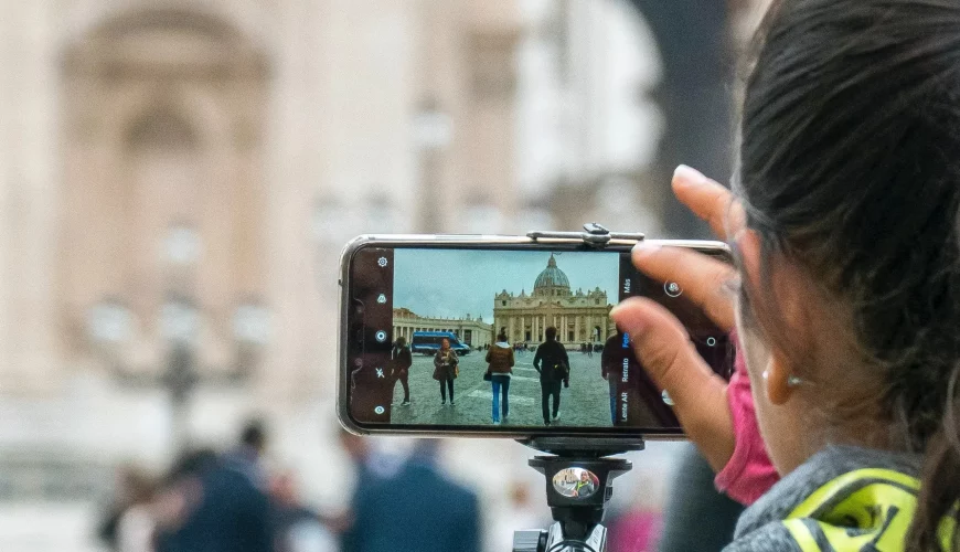 girl taking a picture of st peters basilica